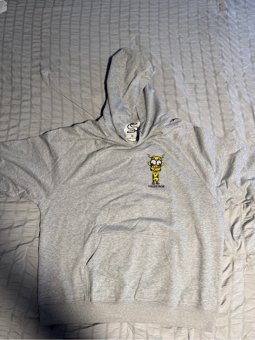 Sole-stage Gray Hooded Sweatshirt with Yellow Character Graphic